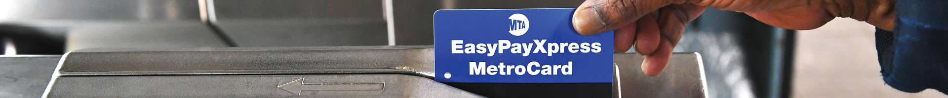 Photo of a blue easypay metrocard swiping at a subway turnstile. 