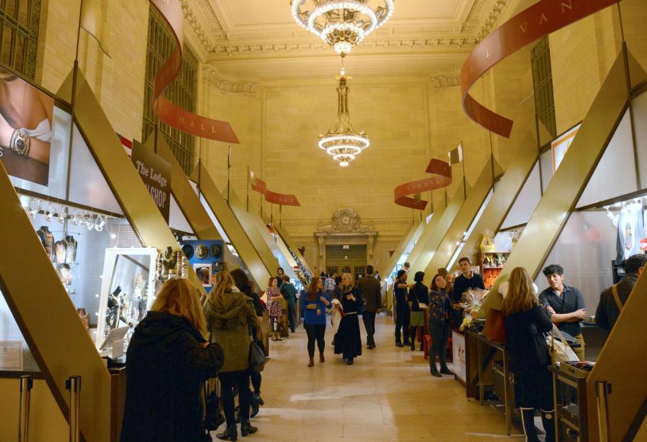 Shoppers walk through an indoor holiday market set up in Grand Central Terminal