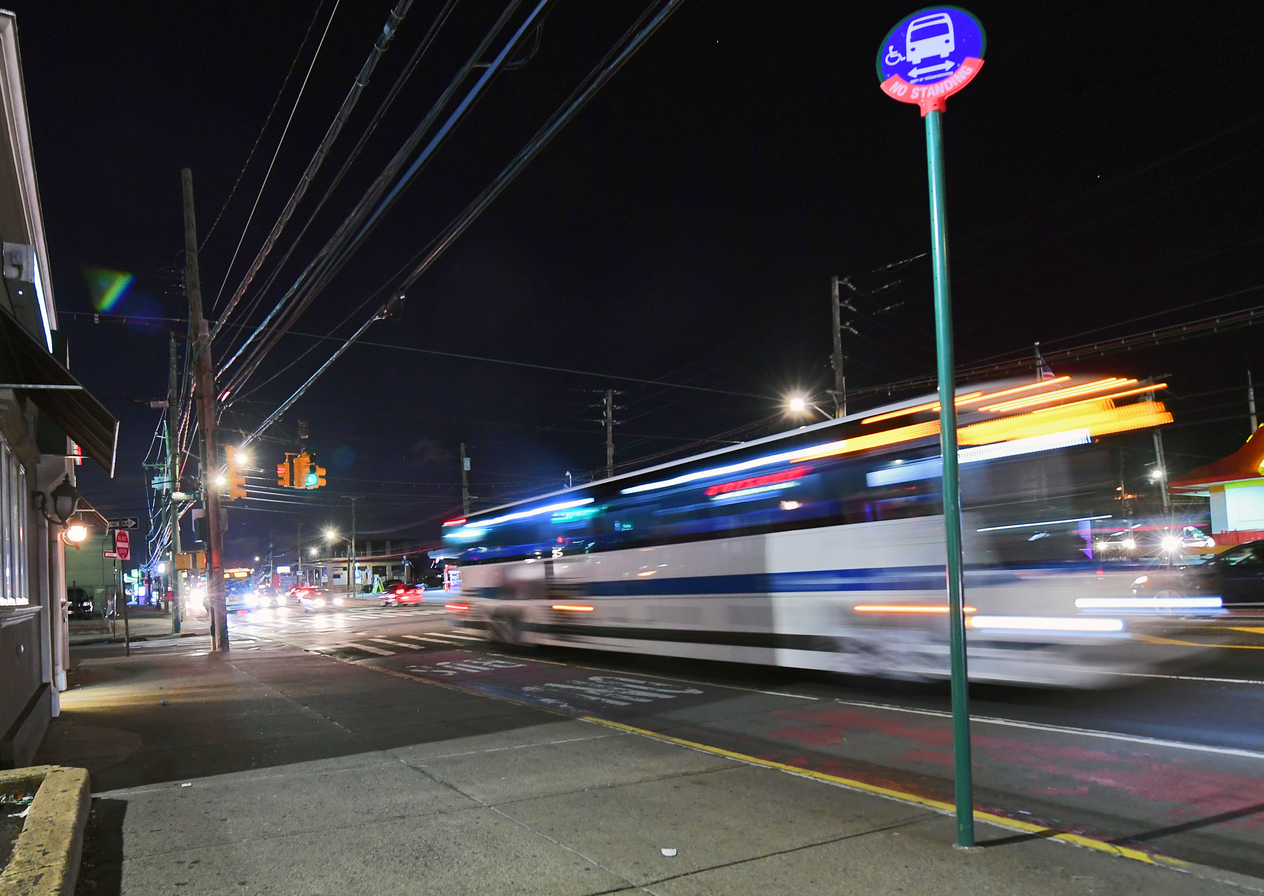 Long exposure shot of a bus pulling up to a stop.