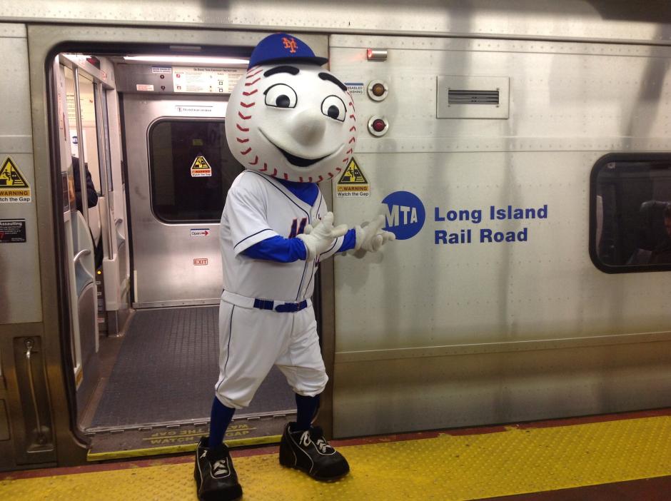 The baseball mascot Mr. Met next to a Long Island Rail Road train. 